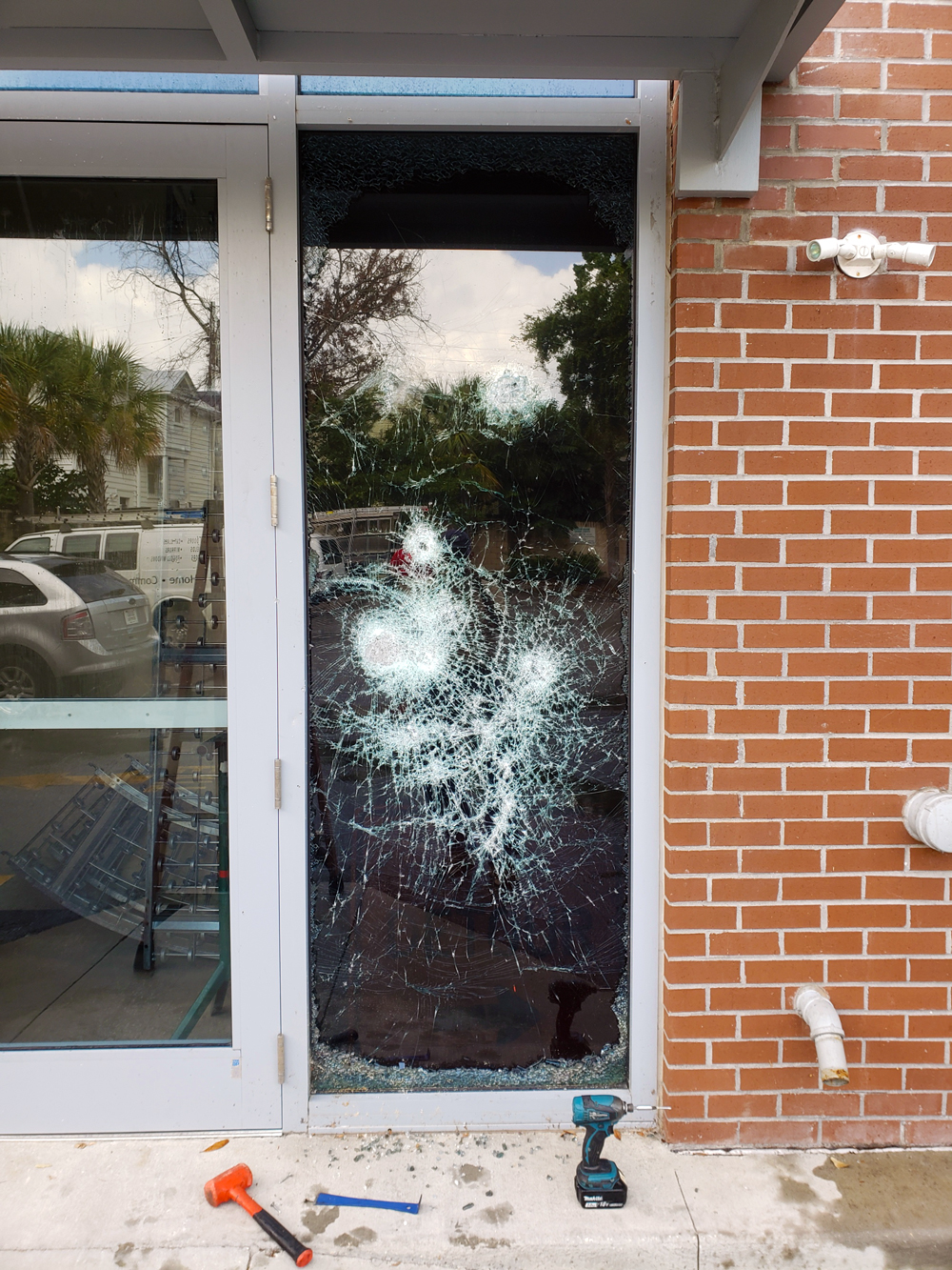 A Glass door panel with major damage  